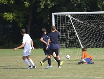 NCHS Rams varsity soccer team senior striker Chase Ashley had a "hat trick" in the squad's 4-1 preseason victory over Weston. Here he is scoring a goal. Photo by Christine Betack