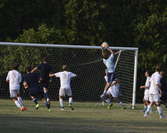 New Canaan High School Rams varsity boys soccer goalie Griffin Paterson makes a save during a scrimmage game on Sept. 8, 2015. Photo by Christine Betack