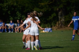 Sophomore Braeden Dial celebrates with a couple of her teammates on what turned out to be the game-winning goal.