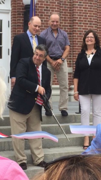 First Selectman Rob Mallozzi cuts a ribbon on the front steps of Town Hall, officially dedicating the newly renovated and expanded public building at 77 Main St., on Sept. 12, 2015. At far right is Kathleen Corbet of the Town Council, a member of the Town Hall Building Committee, as is Board of FInance member Neil Budnick, standing beside her, and Michael Anthony, far left. Rob Mallozzi IV photo