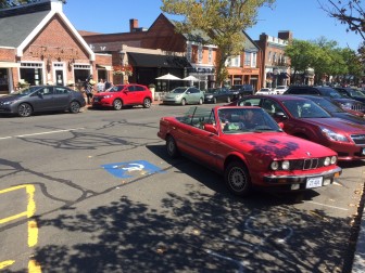 A portion of this vehicle is parked in a handicapped space, from Sept. 6 on Elm Street. Credit: Michael Dinan