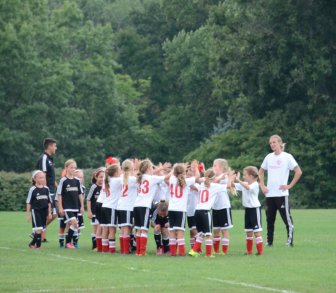 New Canaan Red U-9 Girls celebrate their pre-season win over Trumbull. Contributed