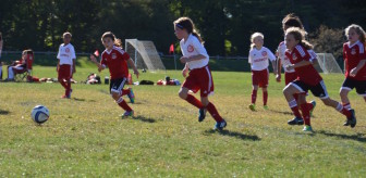 U9 Red shows Greenwich how to hustle toward a ball. Contributed