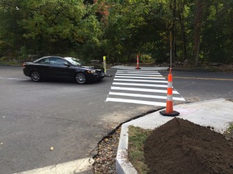DPW workers have striped a new pedestrian crosswalk that spans Old Norwalk Road at Old Kings Highway, hooking up with a trail that skirts the edge of Kiwanis Park and, ultimately, sidewalks that connect to Main Street and Farm Road. Credit: Michael Dinan