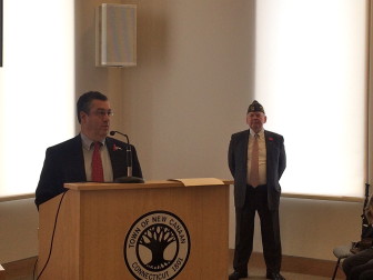 First Selectman Rob Mallozzi addresses those gathered at the Veterans Day ceremony in Town Hall on Nov. 11, 2015, while Peter Langenus, commander of VFW Post 653, looks on. Credit: Michael Dinan