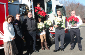 Members of the New Canaan Fire Department delivery poinsettias to Waveny Care Center. Contributed 