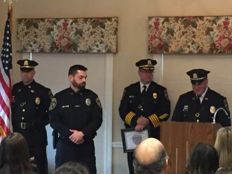 New Canaan Police Officer Bryan Connolly (foreground, left) received the Meritorious Police Duty Award during a Feb. 23, 2016 ceremony. Standing in background are Sgt. Aaron LaTourette (L) and Police Chief Leon Krolikowski. Capt. Vincent DeMaio at podium. Elizabeth Oei photo 