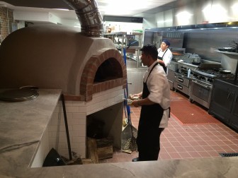The wood-fired oven at Gates anchors one corner of a new food bar overlooking the open kitchen. Credit: Michael Dinan