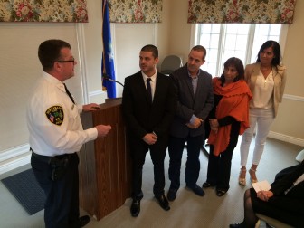 Police Chief Leon Krolikowski addresses newly sworn-in Officer Sebastian Obando and his family during a ceremony held March 24, 2016 at Lapham Community Center. Credit: Michael Dinan