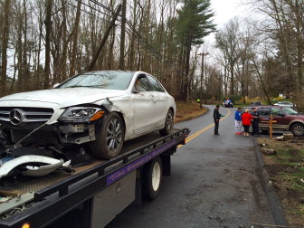 The motorist's car is towed away from the area of 248 North Wilton Road following a single-car accident on March 28, 2016. Credit: Michael Dinan