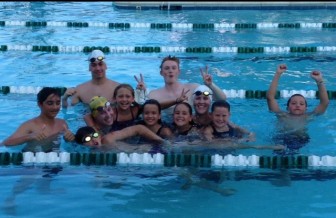 With Shore and Country swimmers after the Coaches Relay at the annual Nickname Relays. Kelly is in the white cap, right center. Photo courtesy of Kat Munson