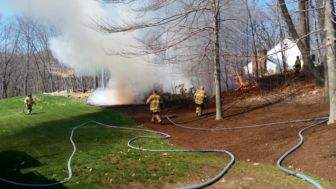 Firefighters control a brush fire at 149 Parish Road South on April 20, 2016. Photo published with permission from its owner