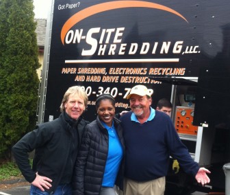 New Canaan residents Mike Bacon (L) and Jeb Swift (R) with Bankwell personal banker Radeka Parchment during the Elm Street bank's "Shred Day" on April 9. Contributed