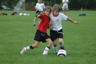 Mia competing hard for the ball on her third grade travel soccer team. Credit: Amy Murphy Carroll