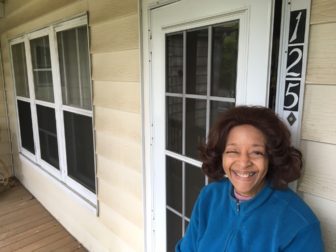Jackie Olowo (née Walker) on her East Avenue porch saw January's windstorms take down a section of fencing. A Summer Street woman on April 26 filed a blight complaint with the town. Credit: Michael Dinan