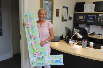 Executive Director of the Chamber of Commerce Tucker Murphy displays the Sidewalk Sale's layout of businesses and vendors Photo Credit: Kim Devine 