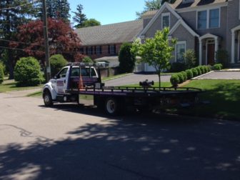 An AC Auto Body truck parked in front of a residence on East Maple Street on June 21, 2016. Photo published with permission from its owner