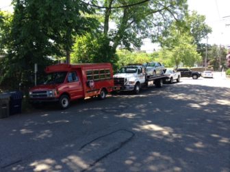Vehicles from AC Auto Body parked beyond the business's designated area on East Maple Street on June 21, 2016. Photo published with permission from its owner