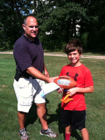 Connor Lytle won the tie breaker of the NFL's Pass Punt & Kick contest in 2016, and is shown recieving the winners ball from Steve Dayton, League Commissioner. Contributed