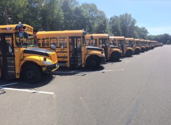 School buses lined up at New Canaan High School ahead of the 2016-17 academic year. Credit: Terry Dinan