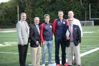Dr. Brian Luizzi, Selectman Nick Williams, First Selectman Rob Mallozzi and NCHS Principal William Egan pose with Olympians Andrew Campbell and Charlie Cole prior to the game. Credit: Terry Dinan