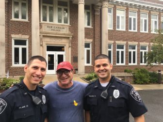 Two of the three men pictured here are new officers in the New Canaan Police Department. The third attended St. A's with Steve Benko and is now a wine expert and parking commissioner. Officers Matthew Blank (L) and Sebastian Obando (R) started at NCPD on Friday, Sept. 16, 2016. Rick Franco was walking past on South Avenue when we took this photo outside NCPD headquarters. Credit: Michael Dinan