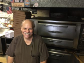 Tommy Romas has worked the ovens at New Canaan Pizza since 1983. Credit: Michael Dinan