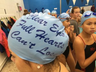 Special swim caps were a feature of the inaugural 'Kelly Devine Dual' meet between NCHS and Norwalk High School, on Oct. 23, 2016 at the New Canaan Y. Credit: Michael Dinan