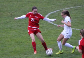 Julia Ozimek attempts to send the ball up the field in New Canaan girls soccer's CIAC Class LL first round game on Nov. 9, 2016. Credit: Samantha Loomis