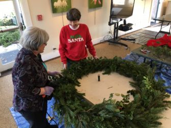 Susan Bergen and Sara Hunt work on a wreath on Dec. 1, 2016 at New Canaan Nature Center. Credit: Michael Dinan