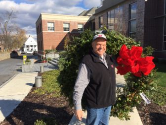 Parks Superintendent John Howe taking one of the wreaths created by the New Canaan Beautification League and New Canaan Garden Club, to decorate Town Hall, on Dec. 1, 2016. Credit: Michael Dinan