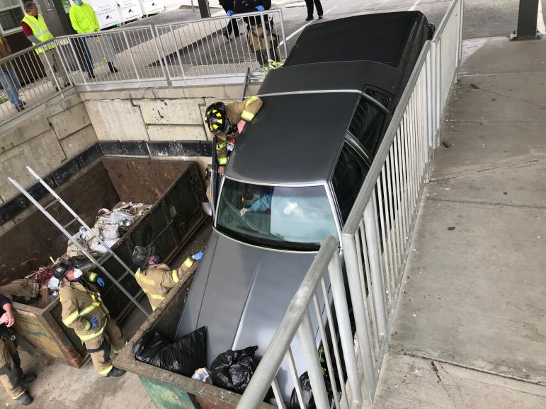 PHOTOS Car Crashes through Rail, into Dumpster at Transfer Station